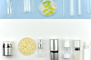 Collection of cosmetic bottle containers and laboratory glassware, Blank label for branding mock-up, Flat lay on color background, Beauty product research and development concept.