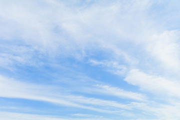 Clear blue sky background with white clouds.