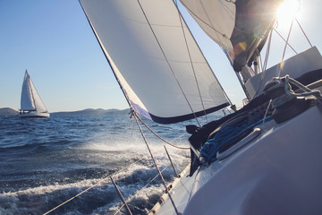 Sailing in the wind through the waves, yachts at sailing regatta - obrazy, fototapety, plakaty