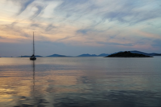 Sunset at sea with small yacht, beautiful nature landscape