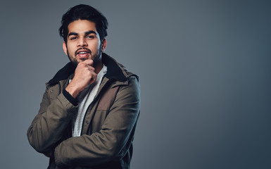 Indian male in a jacket.