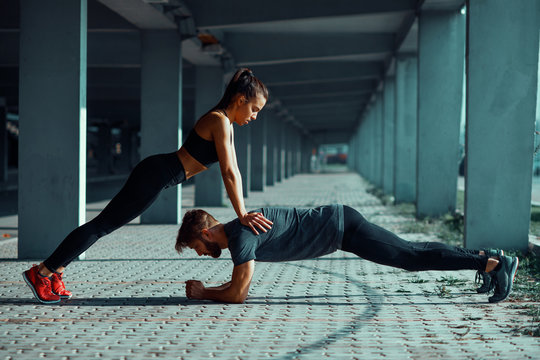 Young sports couple exercising in the urban environment