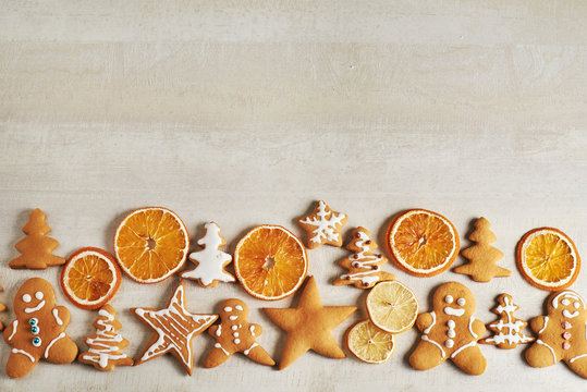 Christmas gingerbread cookies and dried orange and spices on white table © standret