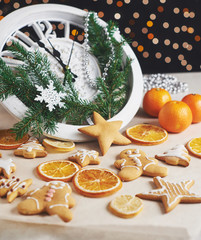 Happy New Year at midnight 2018, Old wooden clock with holiday lights and fir branches. Cooking and decorating christmas gingerbread cookies and fried orange slices