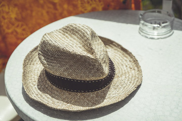 Fototapeta na wymiar old straw hat on a table