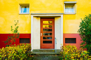 Fototapeta na wymiar colorful picture of entrance door with yellow facade