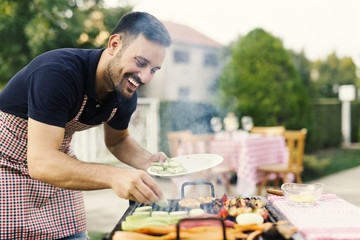 Young man making barbecue