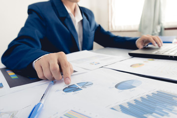 Business and finance investment concept : Businessman check about cost and doing finance graph report at office, Finance managers task,Businessman recheck new plan financial graph data.