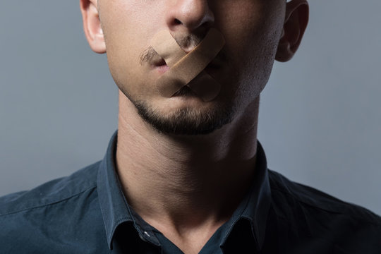 man with mouth covered by patch to forbidden him the free speeching