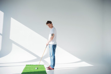 young man playing golf