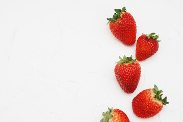Raw of juicy Strawberries on White Background. Fresh Red Berries.