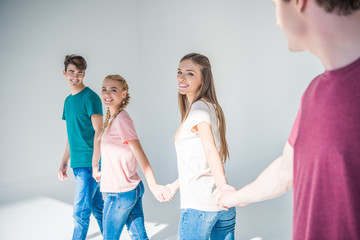 young people holding hands