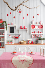Interior light grey kitchen and red christmas decor. Preparing lunch at home on the kitchen concept.