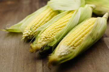 Close up of corns on rustic table. Selective focus applied.