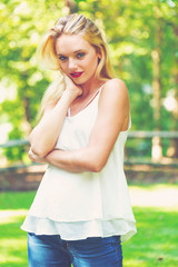 Fototapeta premium Young woman posing outside on a beautiful summer day