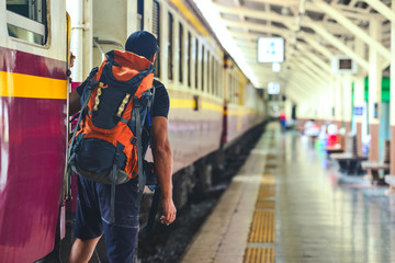 Fototapeta premium Man with backpackwaiting to travel by train