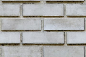 Fototapeta premium Wall from gray brick blocks, seamless texture