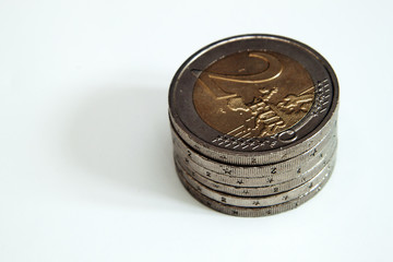 A stack of 2 Euro coins on s white background