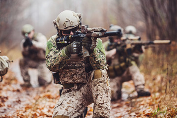soldier with rifle. Military man on the background of nature.