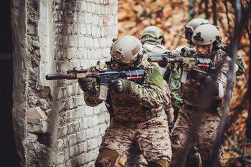 soldiers or private military contractors aiming with rifle. war, army, weapon, technology and...