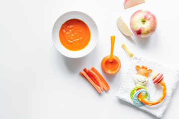 cooking vegetable puree for baby on white background top view