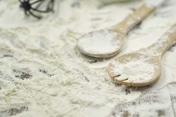 Close up of baking utensils with flour spread on the table. Selective focus applied.