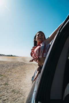 Woman enjoying riding car in desert