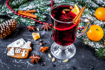 Christmas mulled wine with spices in cup on dark background