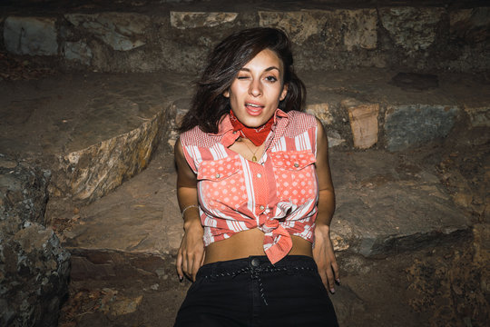 Sensual woman posing on rocky steps