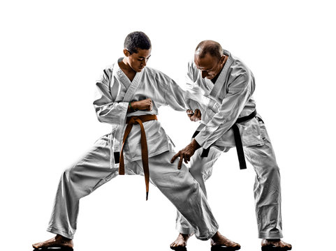 two karate men sensei and teenager student teacher teaching isolated on white background