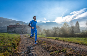 Fototapeta premium Runner athlete professional training on a mountain dirt