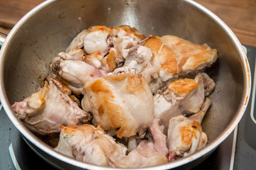 Frying pieces of the rabbit on the pan