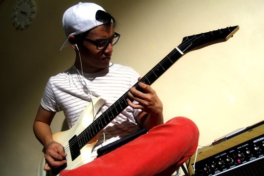 Teen playing an electric guitar