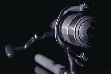 Obraz premium Fishing rod. Spinning reel black and white image.