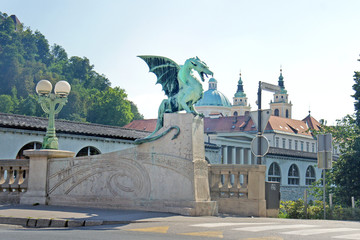 View of Dragon Bridge and towers of Ljubljana Cathedral, sunny day Ljubljana, Slovenia