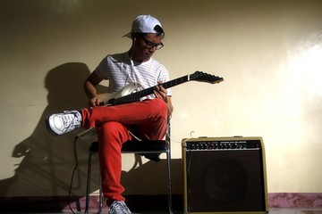 Teen playing an electric guitar