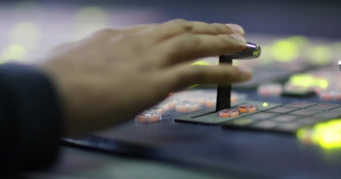 Close-up of hand operating TV control room technology