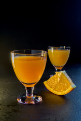 orange drink on a black background.