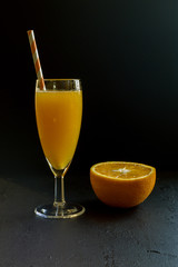 Freshly squeezed orange juice on a dark background.