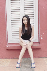 Cute asian girl sitting pose