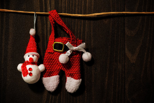 Santa Claus and snowman haning on dark wood wall