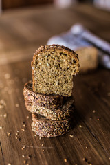 Sliced brown bread on wooden table background