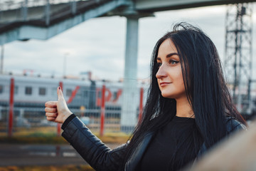 Woman in black dress on the railroad station