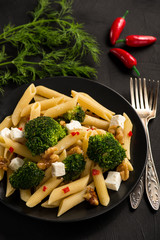 Pasta penne with broccoli, feta cheese and pepper.