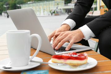 Young man using laptop at table