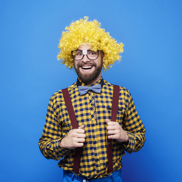 Portrait of happy man with wig .