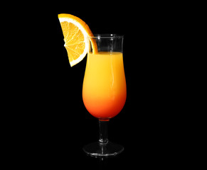 Glass with tasty exotic cocktail on black background