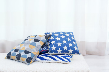 Colorful pillows on floor indoors
