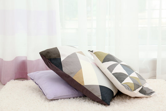Colorful pillows on floor indoors