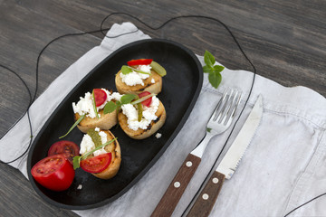 Small vegetarian sandwiches with soft cheese, vegetables and edible greens. Closeup.